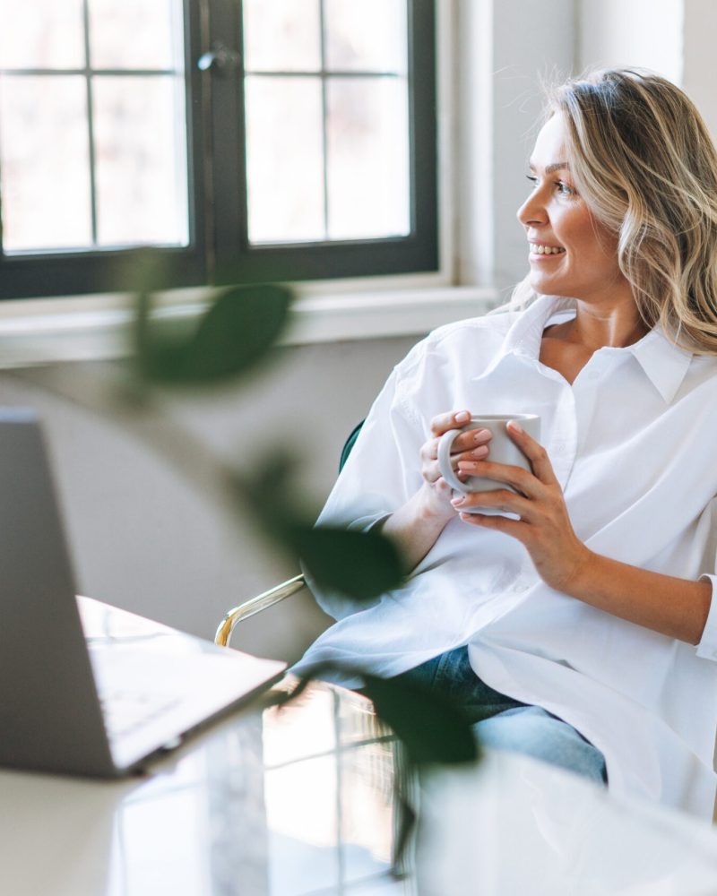 Young,Smiling,Blonde,Woman,With,Long,Hair,In,White,Shirt